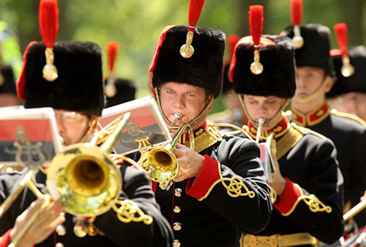 A military band plays as members of the King's Troop Royal Horse Artillery prepare to fire a 41 Gun Royal Salute in Hyde Park to mark Queen Elizabeth II's coronation, London, June 2, 2010