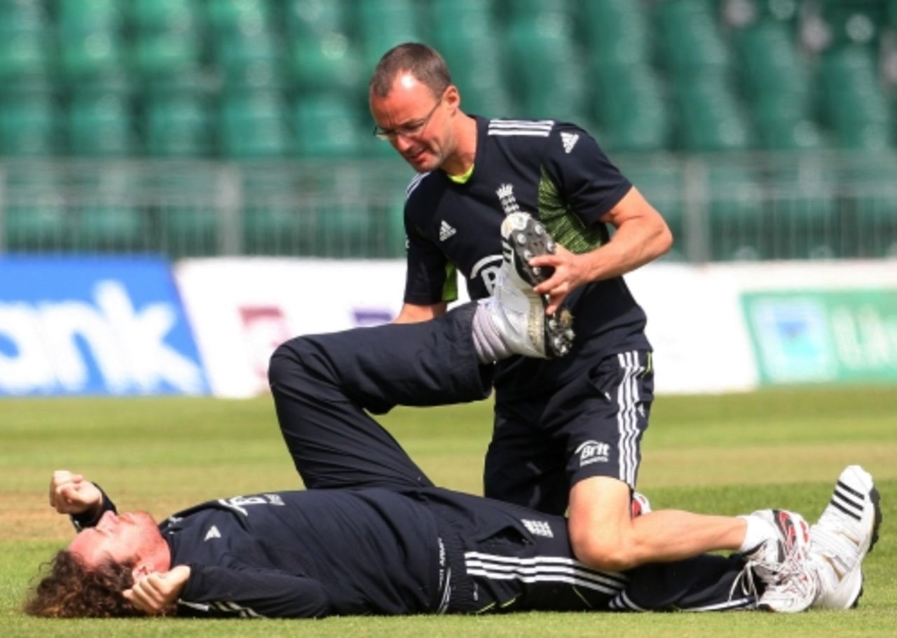 Ryan Sidebottom has his hamstrings stretched during England's practice session, June 18, 2010