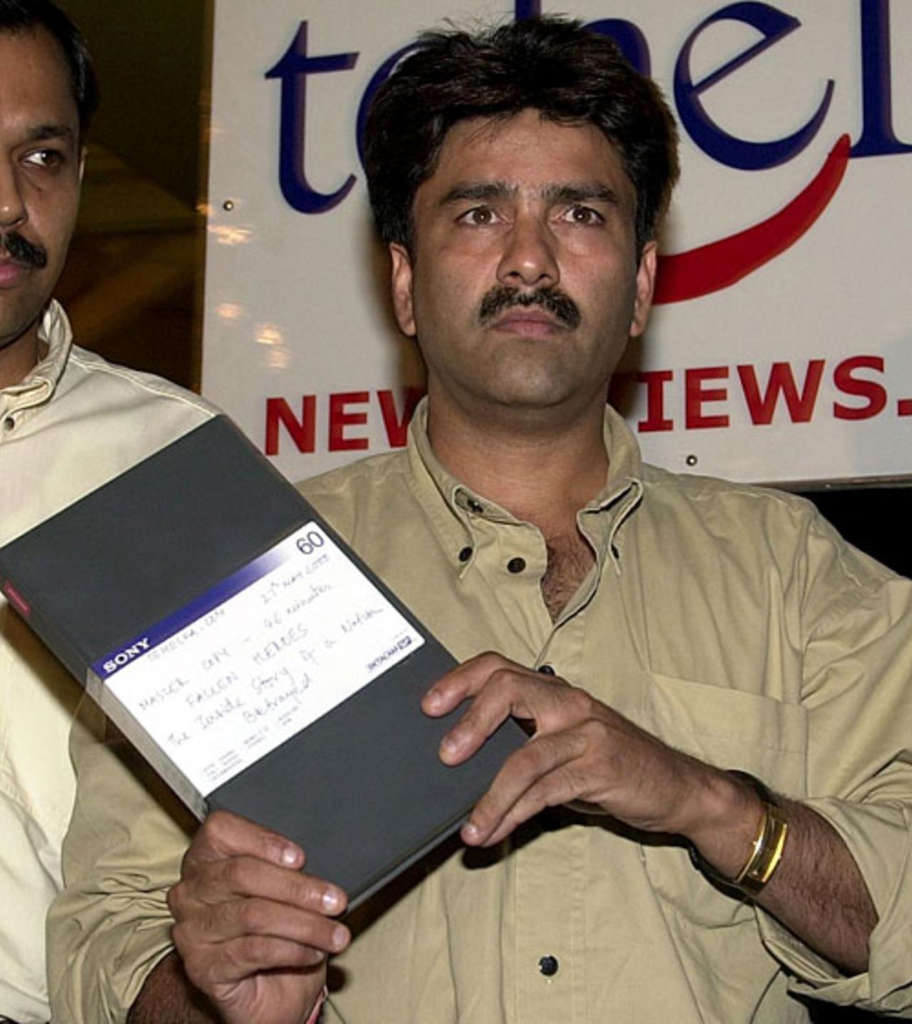 Manoj Prabhakar exhibits a video tape at a press conference, New Delhi, May 27, 2000