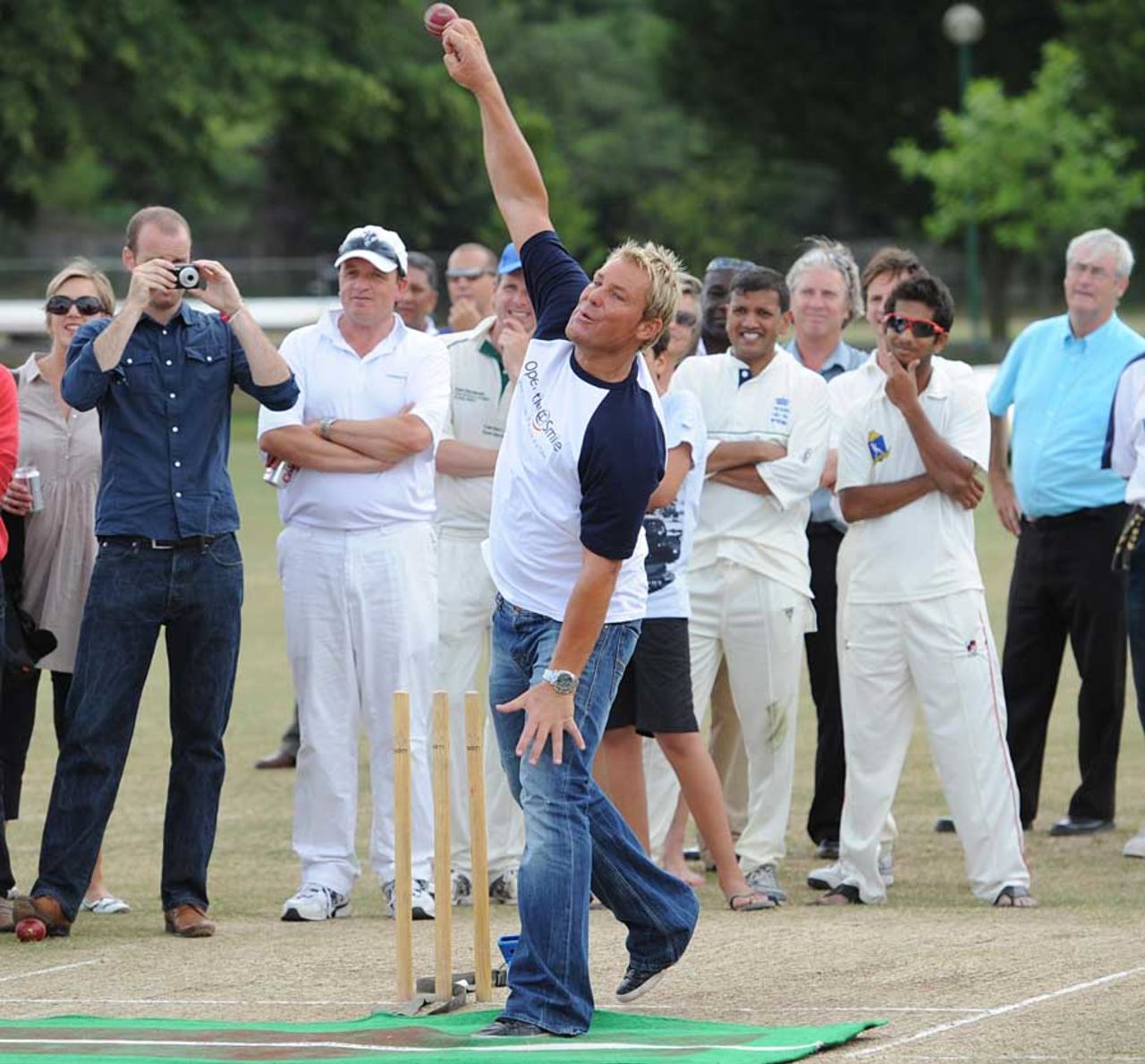 Shane Warne turns his arm over at an event in London, July 2, 2010