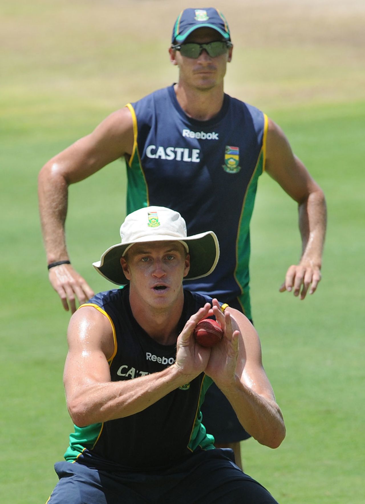 Morne Morkel takes a catch as Dale Steyn looks on during a training session, Bridgetown, June 25, 2010
