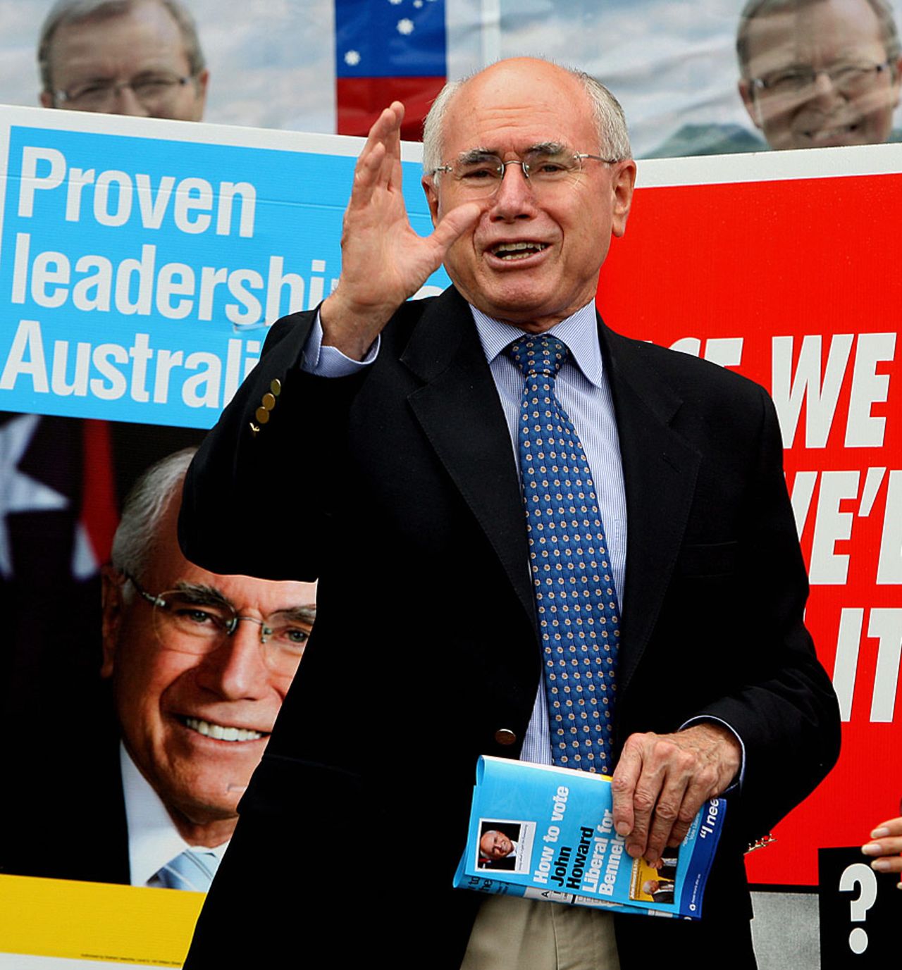 John Howard gestures as he arrives to cast his vote at the Ermington West Public School