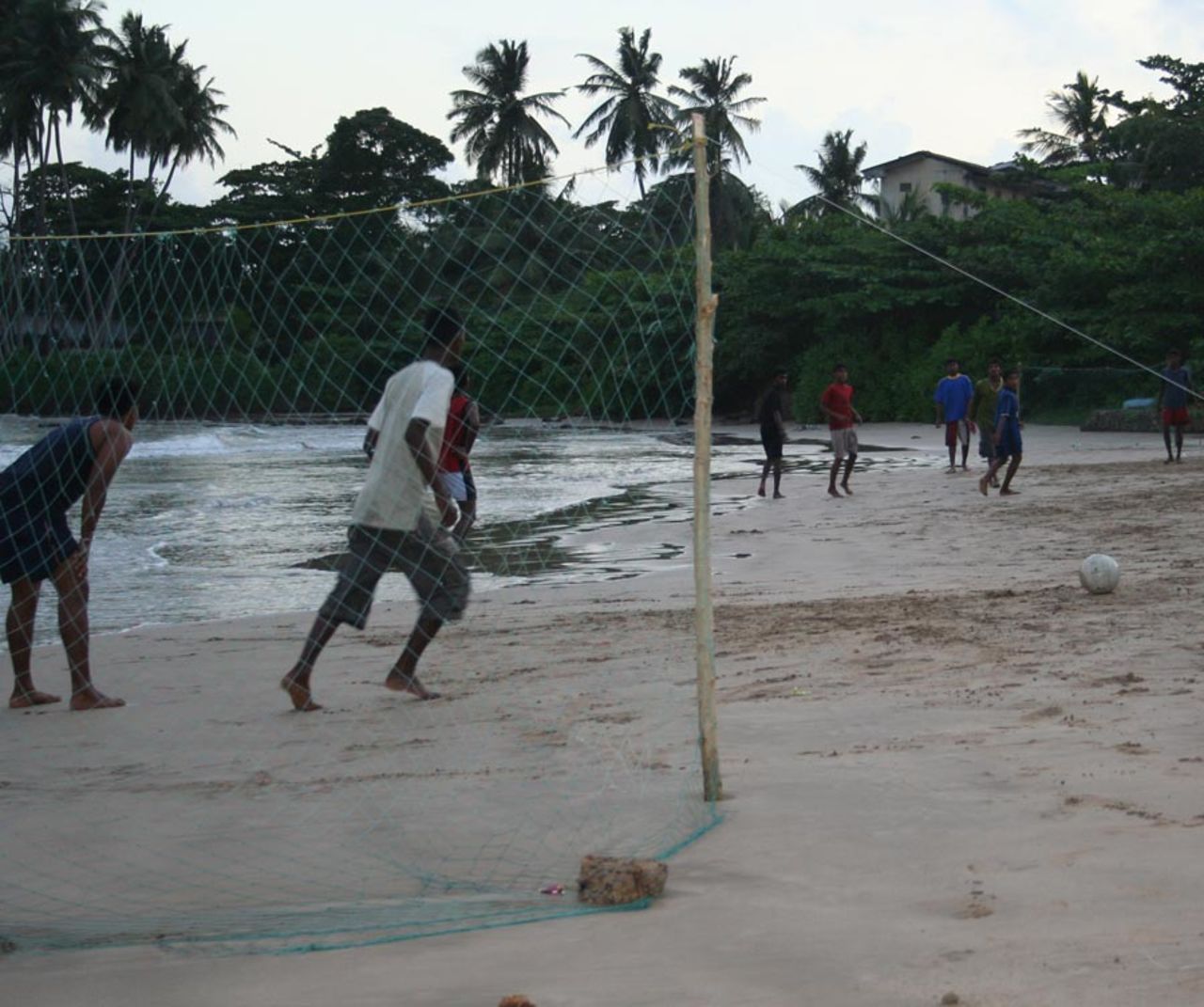 Kids play football on a beach in Galle