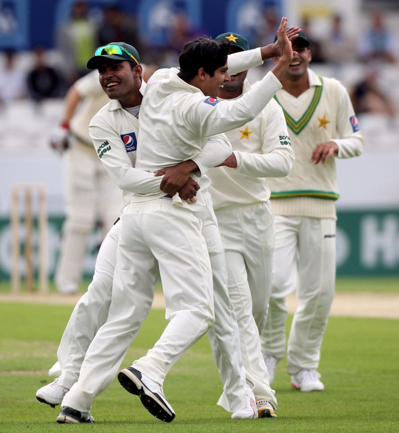 Umar Amin is engulfed by his team-mates after claiming Marcus North as his maiden Test wicket, Pakistan v Australia, 2nd Test, Headingley, July 21, 2010