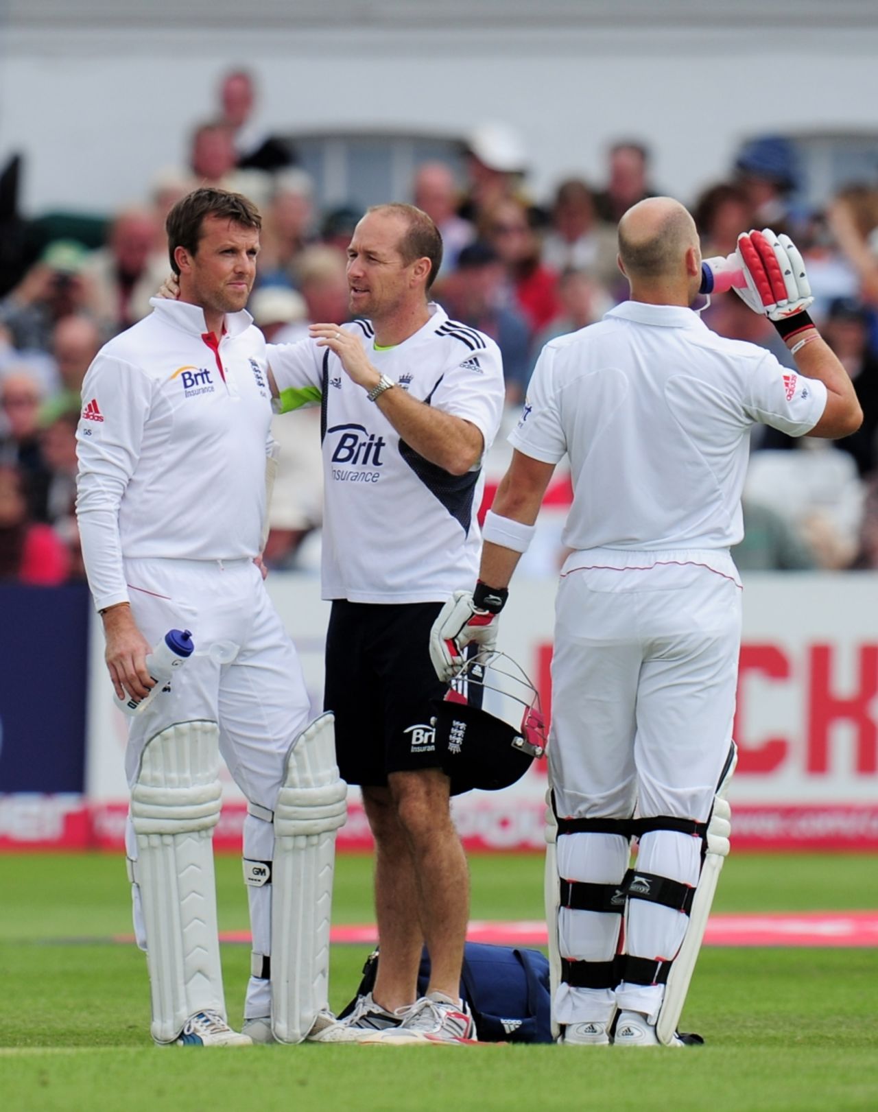 Graeme Swann receives some attention from the England physio after he was struck on the back of the helmet by a bouncer from Umar Gul, England v Pakistan, 1st Test, Trent Bridge, 3rd day, July 31, 2010