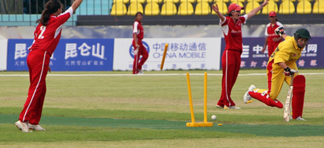 Godiva Li's direct hit effects a run out for Hong Kong Women against Shenyang University at the Guangzhou Cricket Stadium