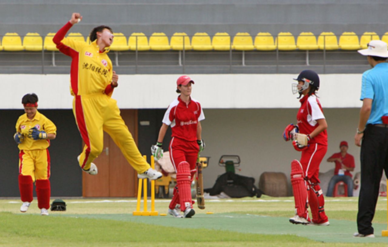 Shenyang University's skipper Wang Meng jumps for joy after dismissing Hong Kong Women's skipper Neisha Pratt at the Guangzhou Cricket Stadium