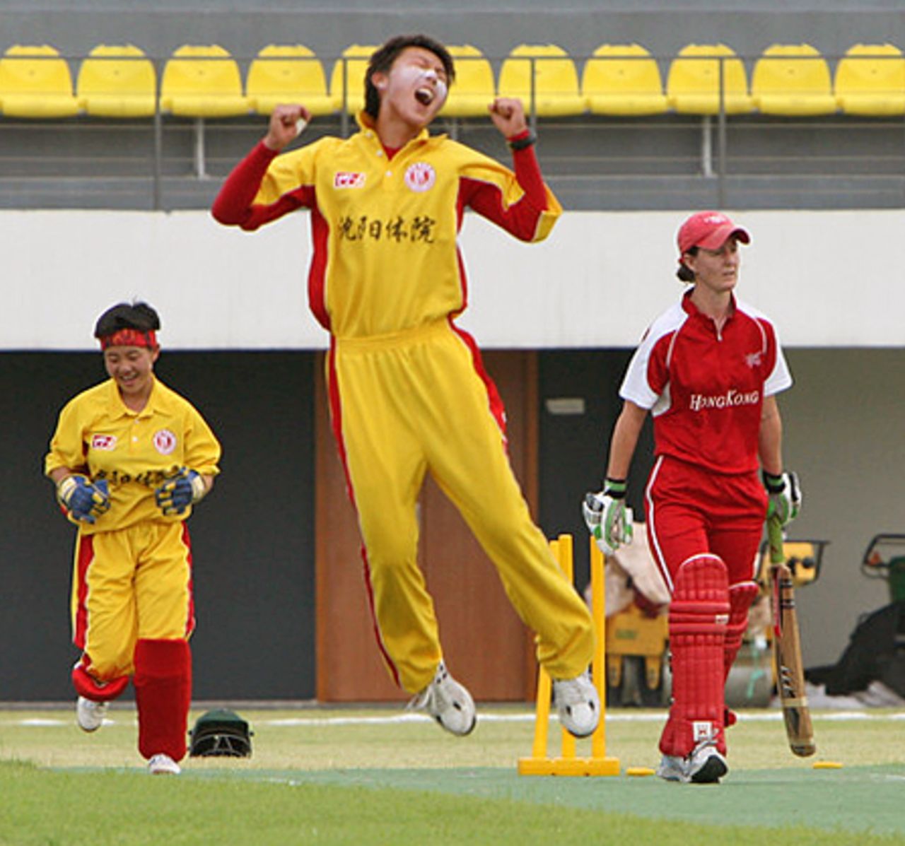 Shenyang University's skipper Wang Meng jumps for joy after dismissing Hong Kong Women's skipper Neisha Pratt at the Guangzhou Cricket Stadium