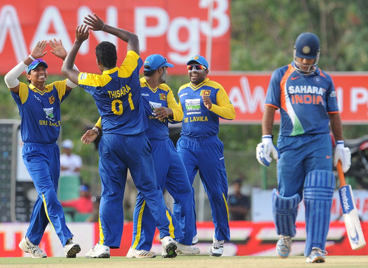 Thisara Perera celebrates the dismissal of MS Dhoni with his team-mates, Sri Lanka v India, tri-series, 5th ODI, Dambulla, August 22, 2010