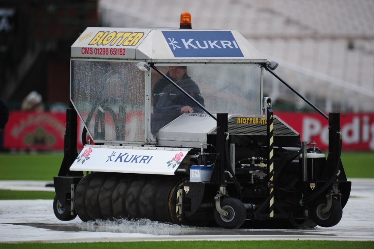 Ground staff at Old Trafford attempt to clear water off the covers, Lancashire v Nottinghamshire, County Championship Division One, Old Trafford, September 15 2010