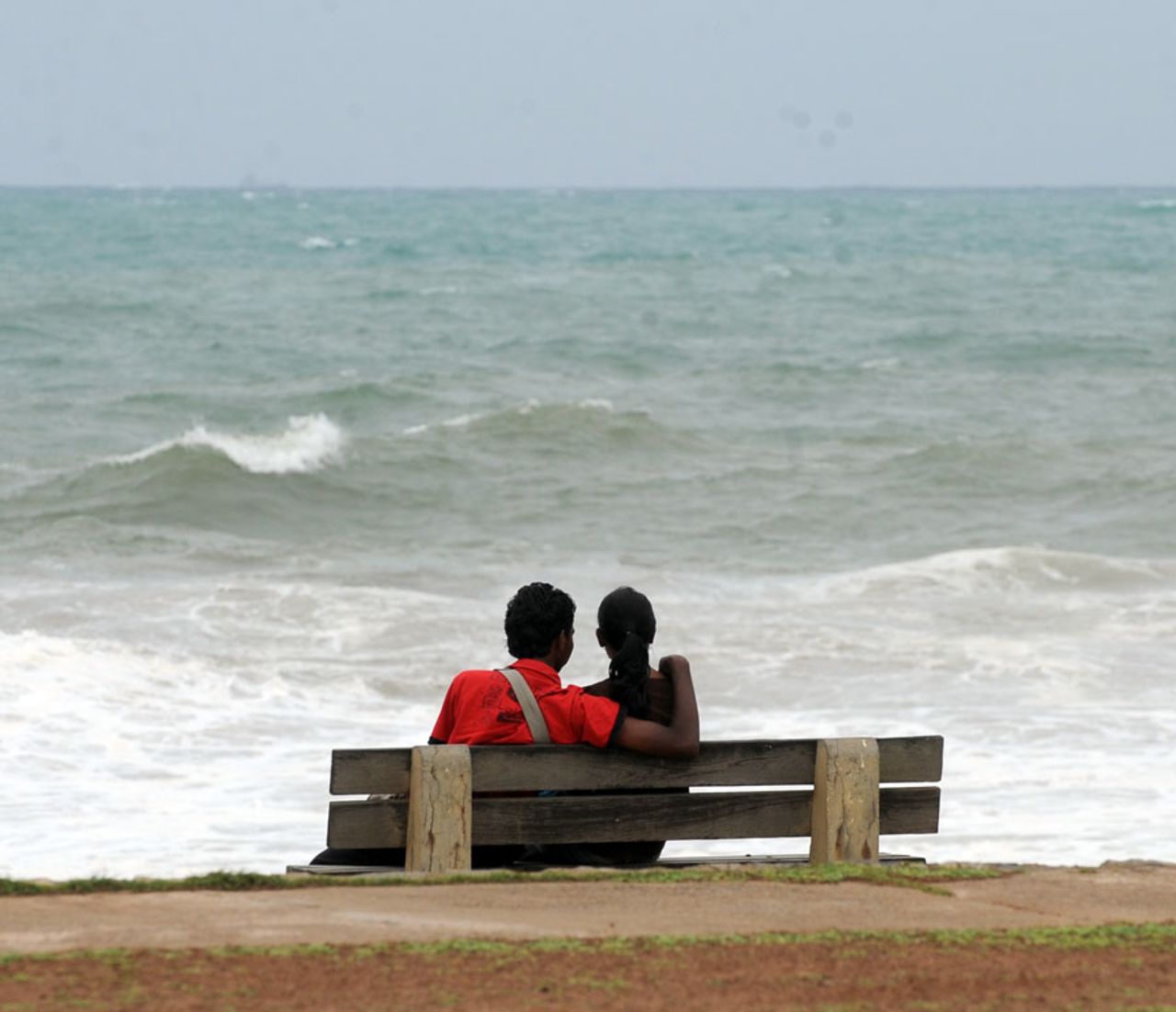 A Sri Lankan couple sits on a bench facing the sea on the Galle Face promenade, Colombo, June 10, 2010