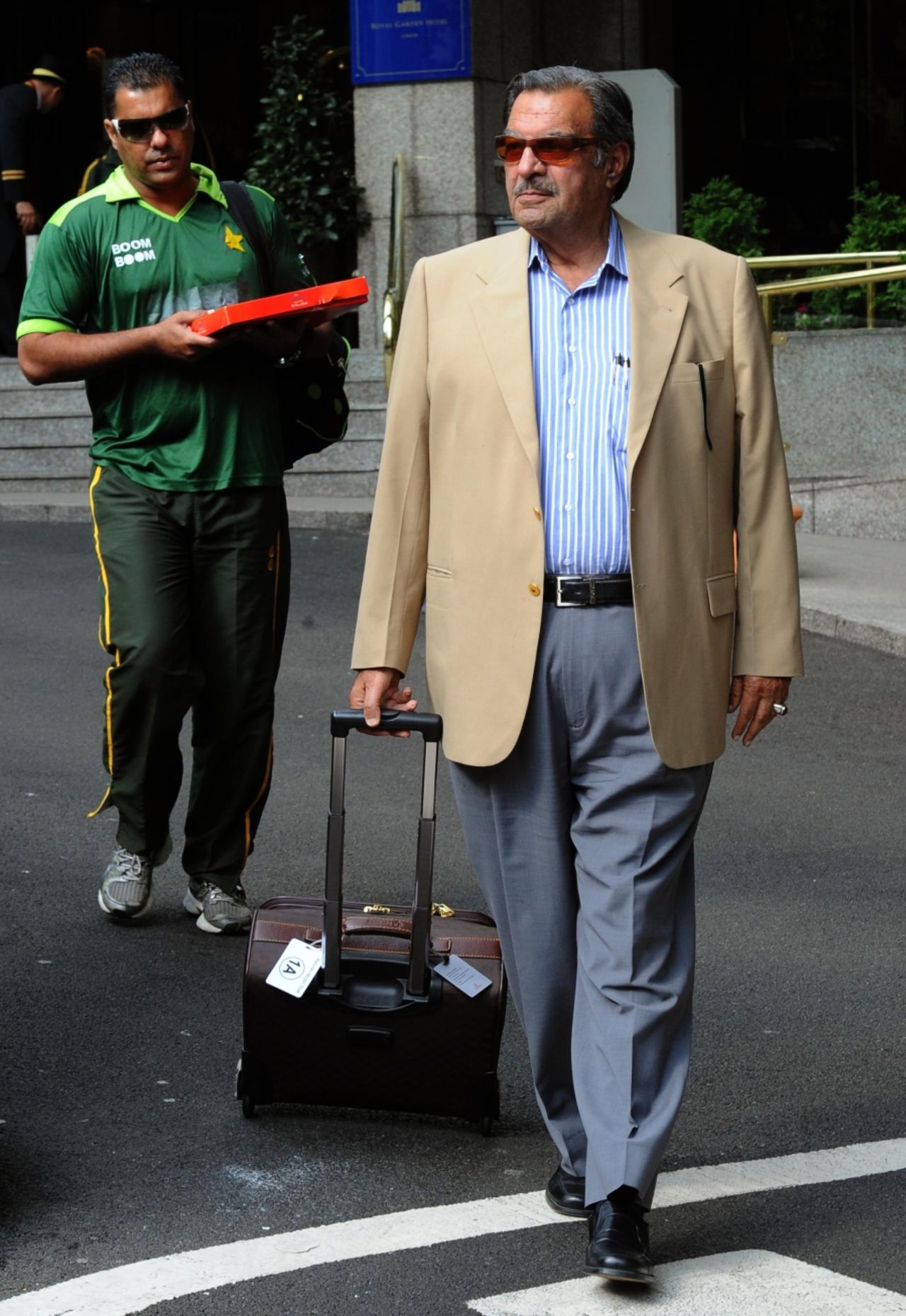 Pakistan team manager Yawar Saeed and coach Waqar Younis leave the team hotel in London, September 21 2010