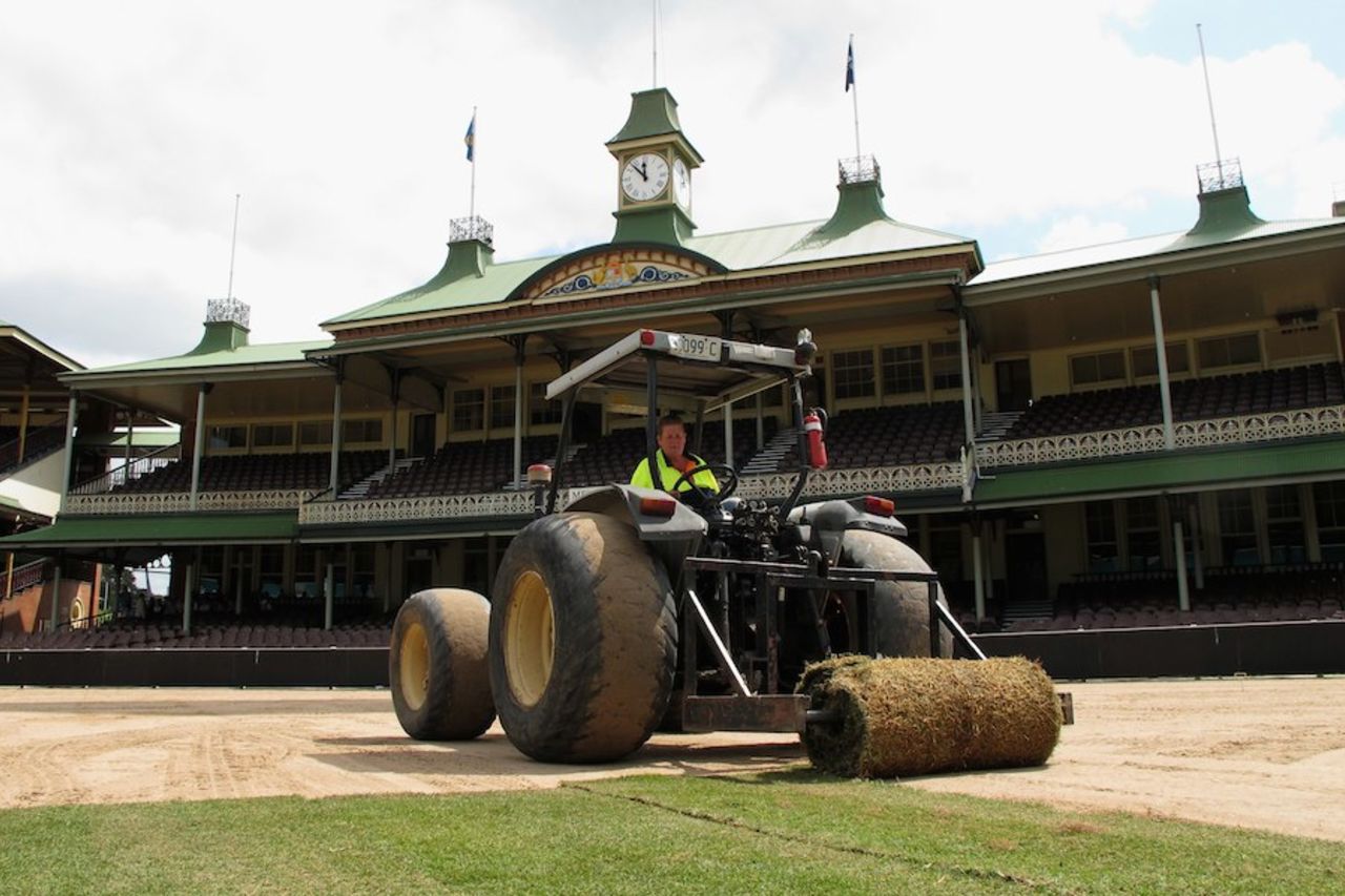 A groundsman lays new turf at the SCG, Sydney, September 22, 2010