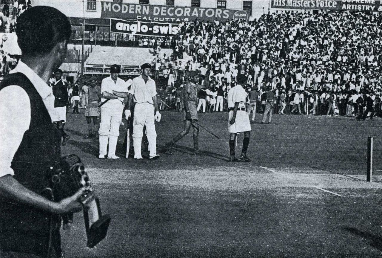 Keith Stackpole and Bill Lawry wait in the middle for order to be restored at the end of the Test , India v Australia, 4th Test, Calcutta, December 16, 1969