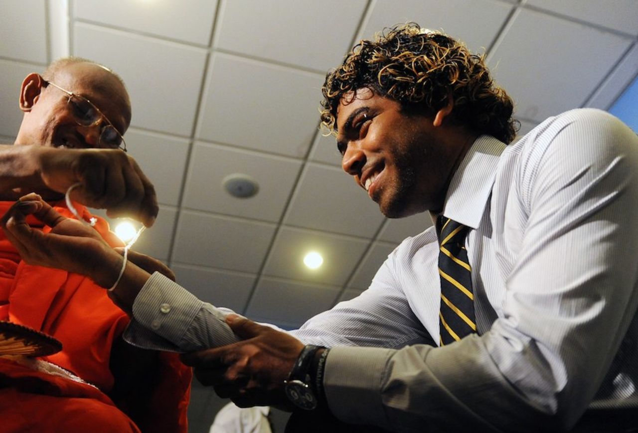 Lasith Malinga takes part in a Buddhist ceremony at SLC headquarters ahead of Sri Lanka's departure for Australia, Colombo, October 18, 2010
