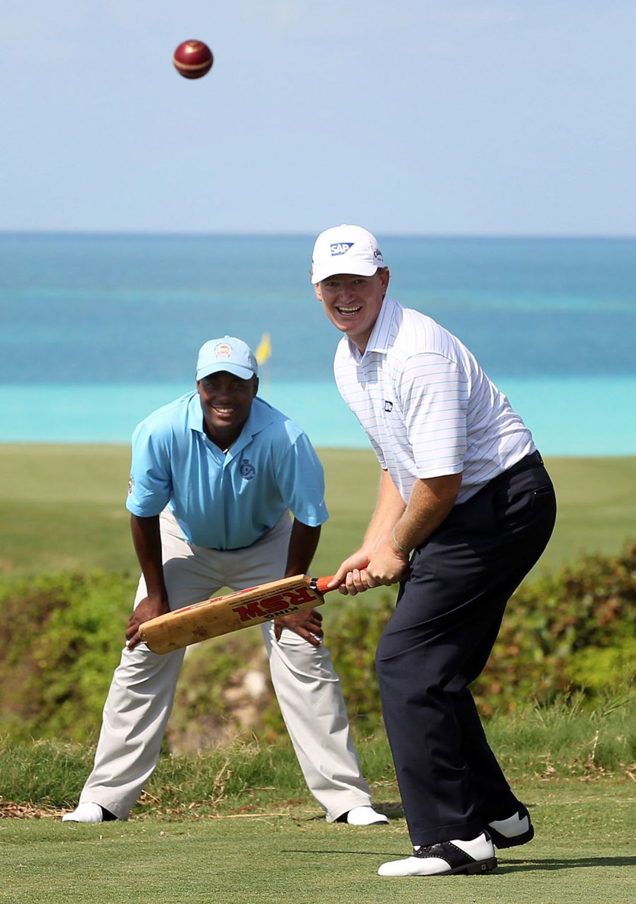 Brian Lara looks on as golf star Ernie Els has a go at cricket ahead of the PGA Grand Slam of Golf, Bermuda, October 18, 2010