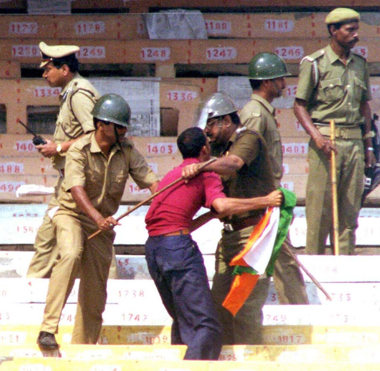 The Calcutta police chase spectators out of the stadium to clear the stands after trouble erupted as the spectators started throwing water bottles and stones onto the playing field during the final day of the inaugural match of the Asian Test Championship. Play was halted and finally resumed after all the spectators were sent out of the stadium. , India v Pakistan, Calcutta, February 21, 1999