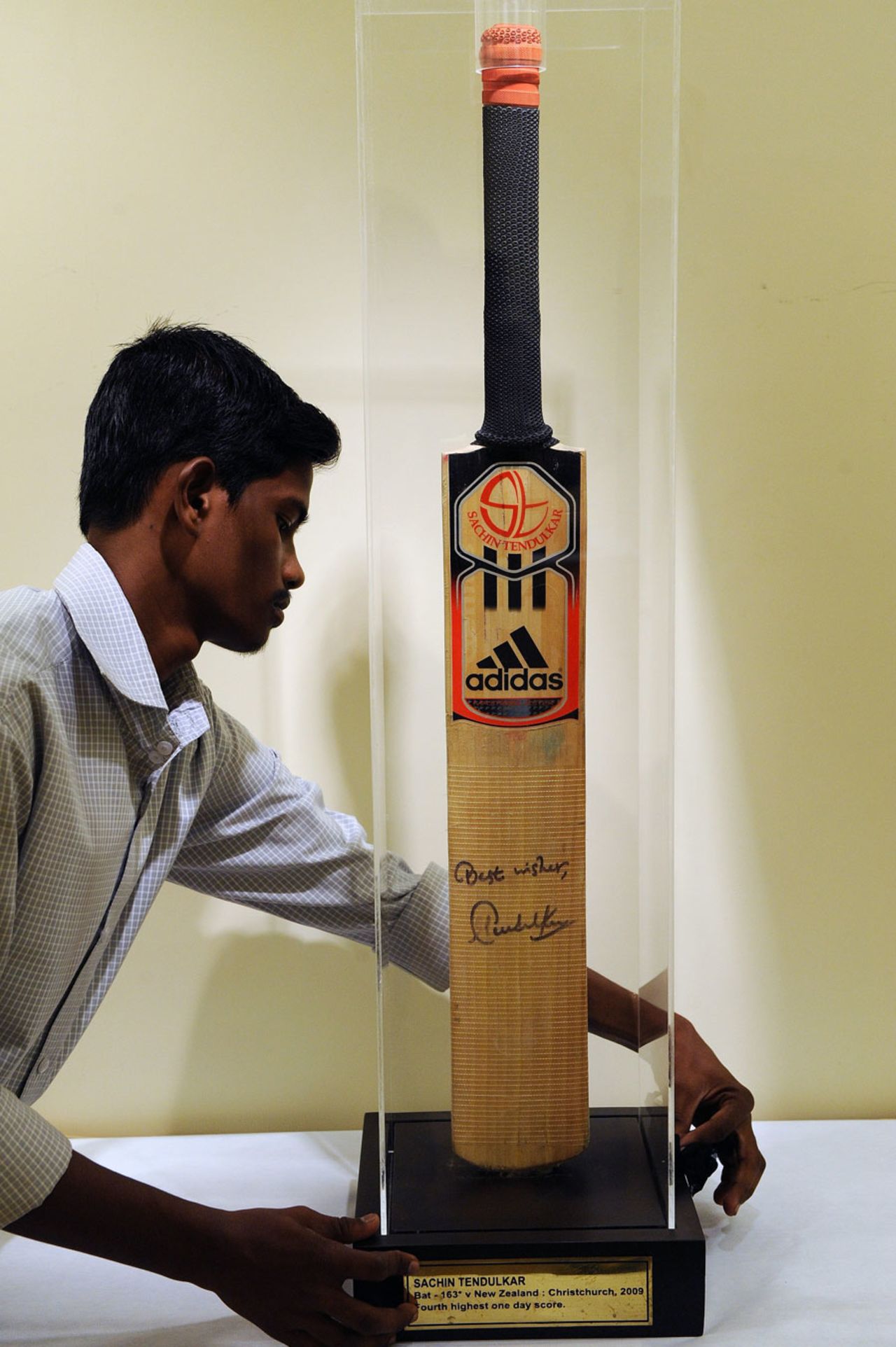 One of Sachin Tendulkar's bats is put on display at an auction, Mumbai, October 26, 2010