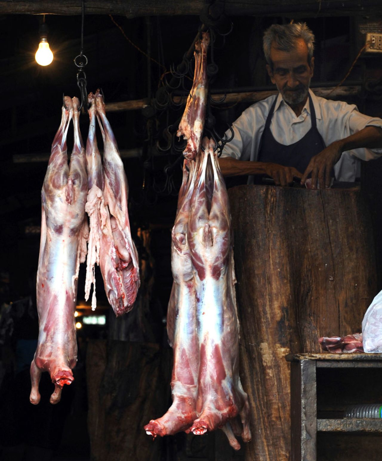 Meat hangs in a long butcher's shop, Bangalore, July 24, 2010