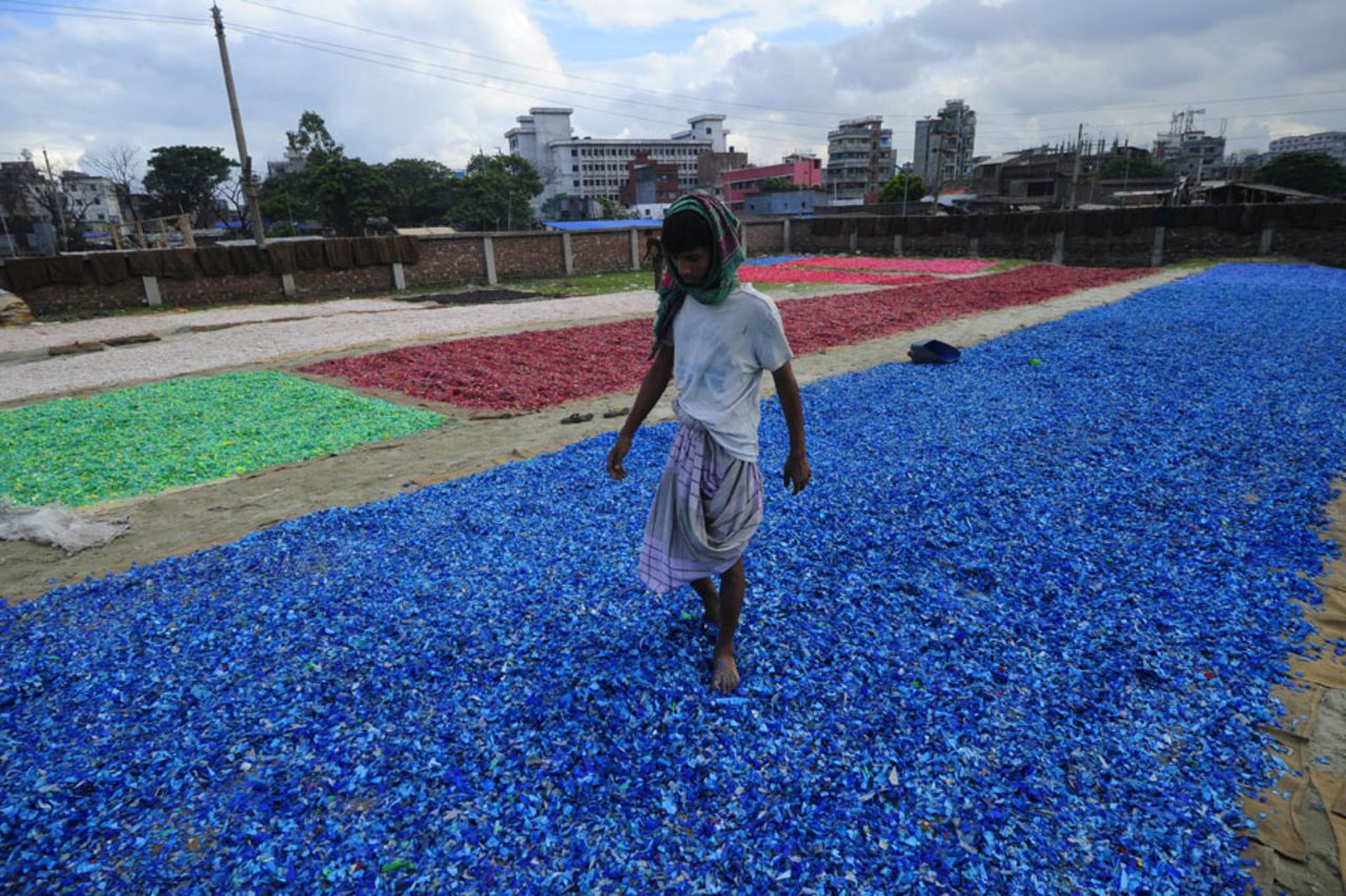 Recycled plastic shards are laid out to dry by a river, Dhaka, August 3, 2010