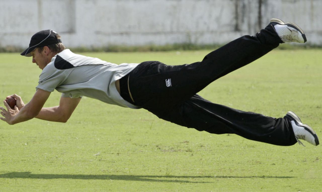 New Zealand's Brent Arnel takes a diving catch at a practice session, Ahmedabad, October 31, 2010