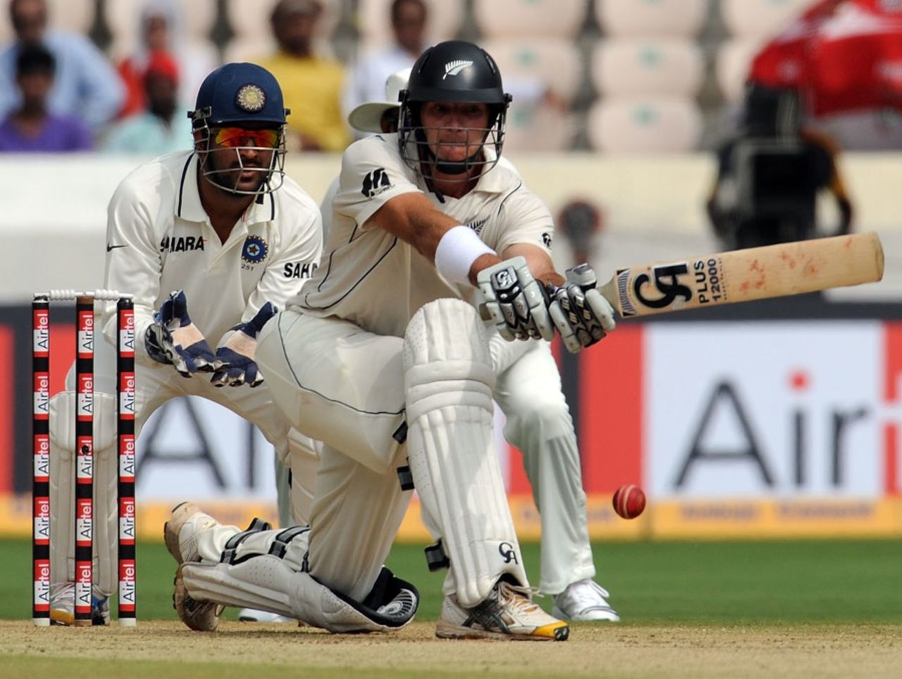 Tim McIntosh sweeps as MS Dhoni watches, India v New Zealand, 2nd Test, Hyderaabad, 1st day, November 12, 2010