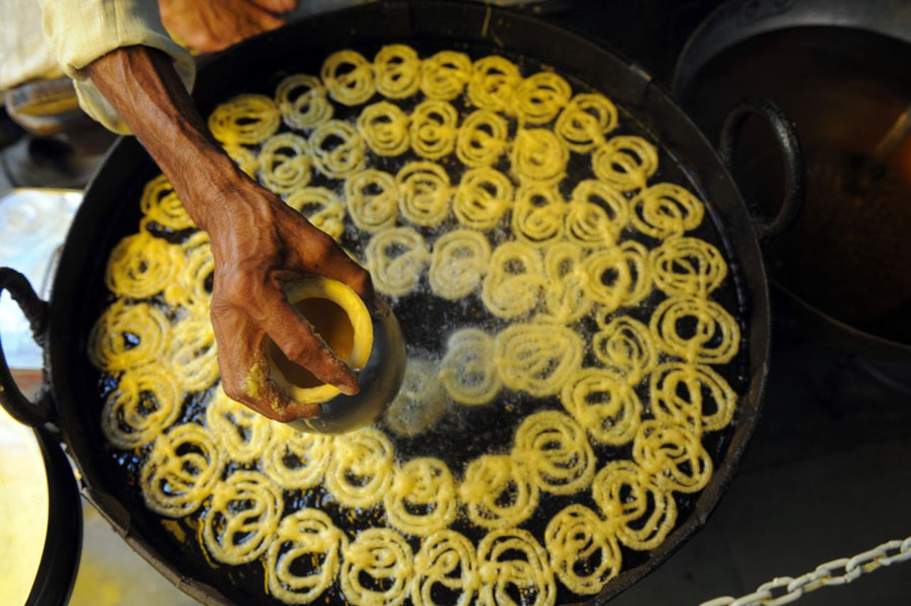 An Indian sweetmaker fries <i>jalebi</i> sweets, Ahmedabad, October 16, 2010