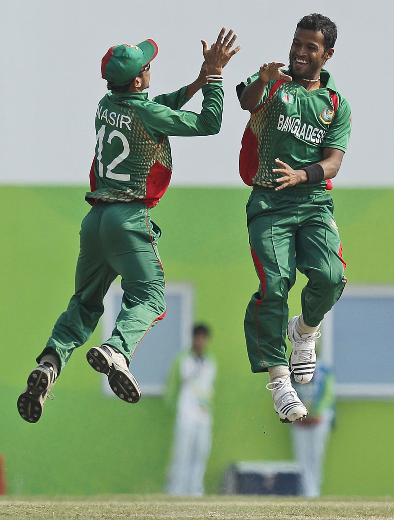 Bangladesh's Nazmul Hossain and Nasir Hossain are mid-air as they celebrate the wicket of Mohammad Shahzad, Afghanistan v Bangladesh, final, Asian Games, Guangzhou, November 26, 2010