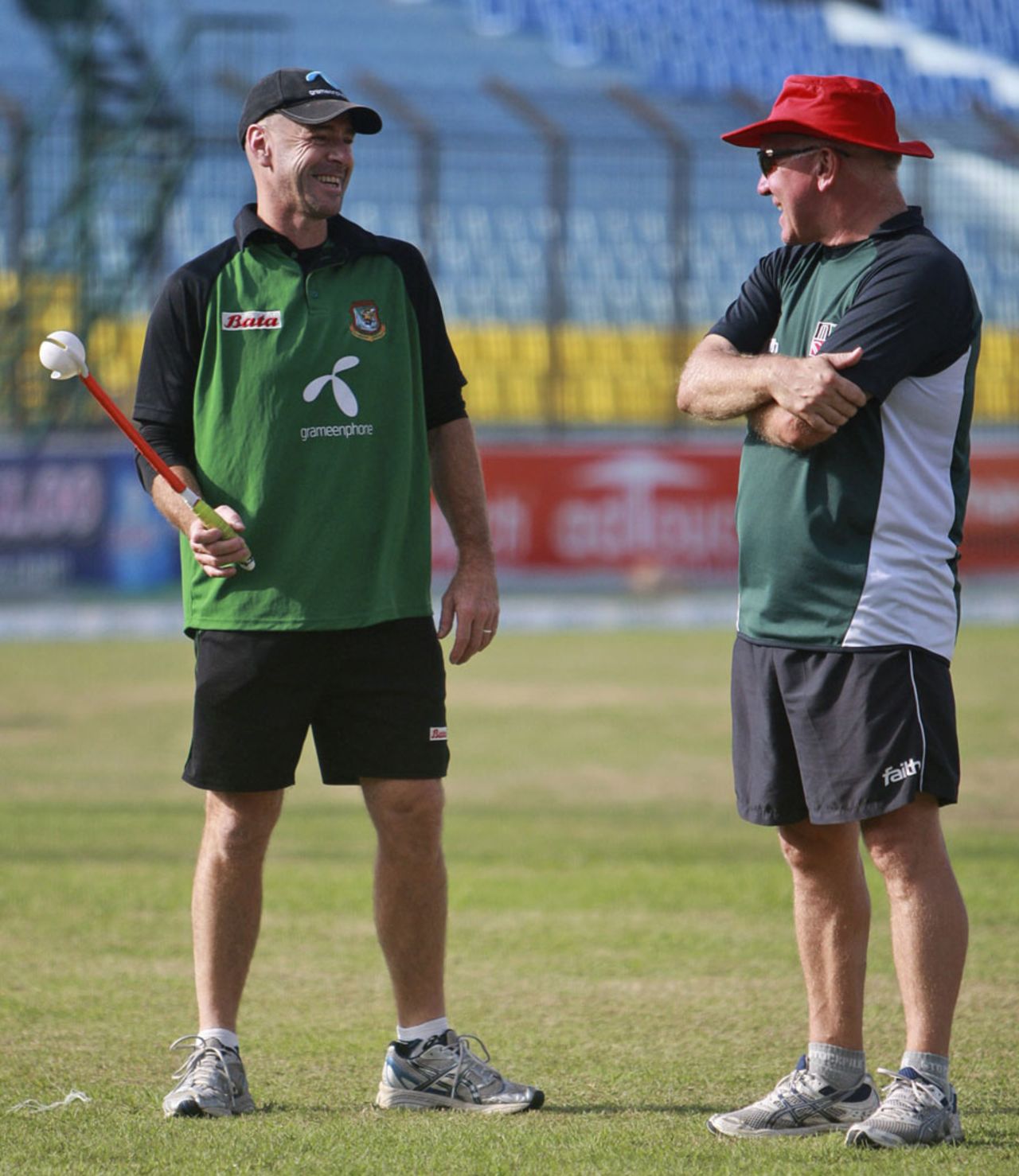 Zimbabwe coach Alan Butcher and Bangladesh coach Jamie Siddons stand on a wet outfield at the Zohur Ahmed Chowdhury Stadium, Chittagong, December 10, 2010