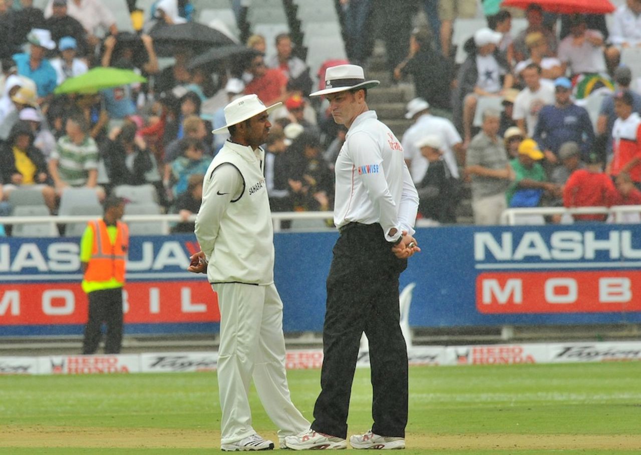 Simon Taufel and Virender Sehwag stand in the drizzle, South Africa v India, 3rd Test, Cape Town, 1st day, January 2, 2011