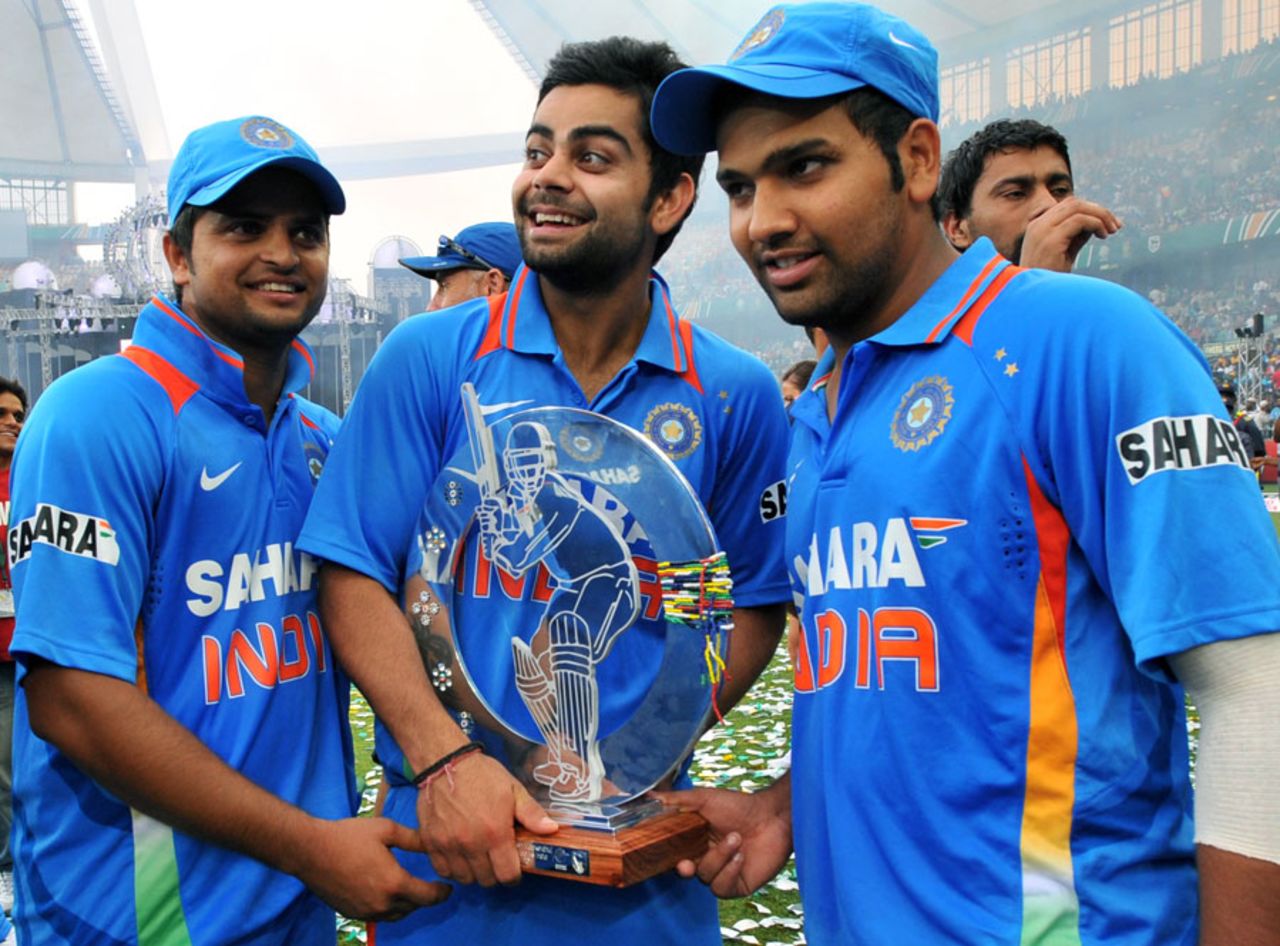 Suresh Raina, Virat Kohli and Rohit Sharma pose with the trophy after winning the one-off Twenty20 international, South Africa v India, only Twenty20, Durban