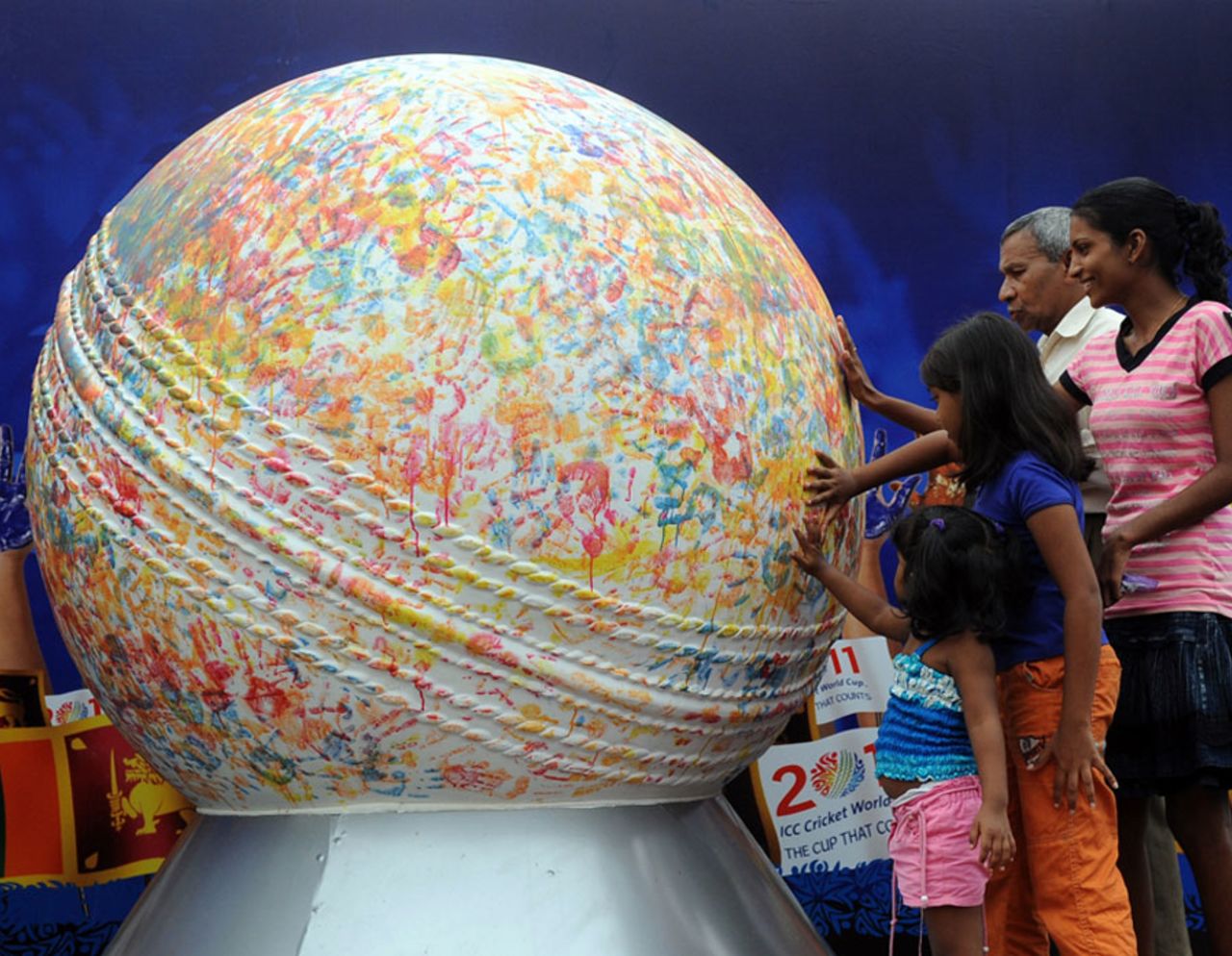 Fans imprint their hands on a giant white ball being taken around Sri Lanka to promote the 2011 World Cup, Colombo, January 11, 2011