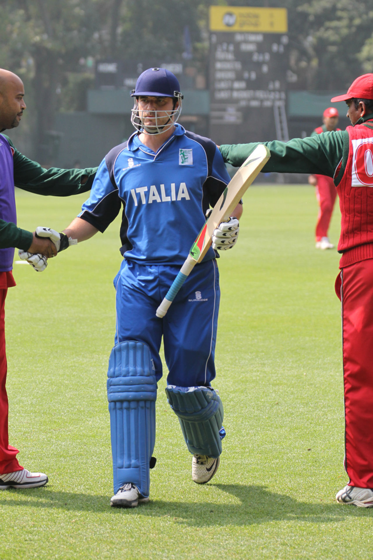 Italy captain Alessandro Bonora is congratulated by the Oman players as he leaves the field after scoring 124 not out in the Pepsi ICC WCL Division 3 match played at Kowloon Cricket Club, Hong Kong, on 25th January 2011