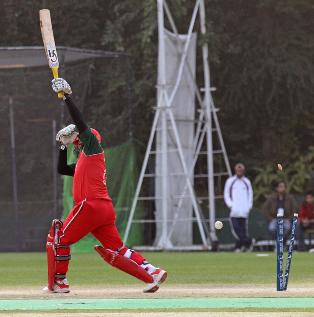 Oman's Awal Khan is bowled against Hong Kong during the ICC WCL Division 3 match played at Kowloon Cricket Club on 23rd January 2011