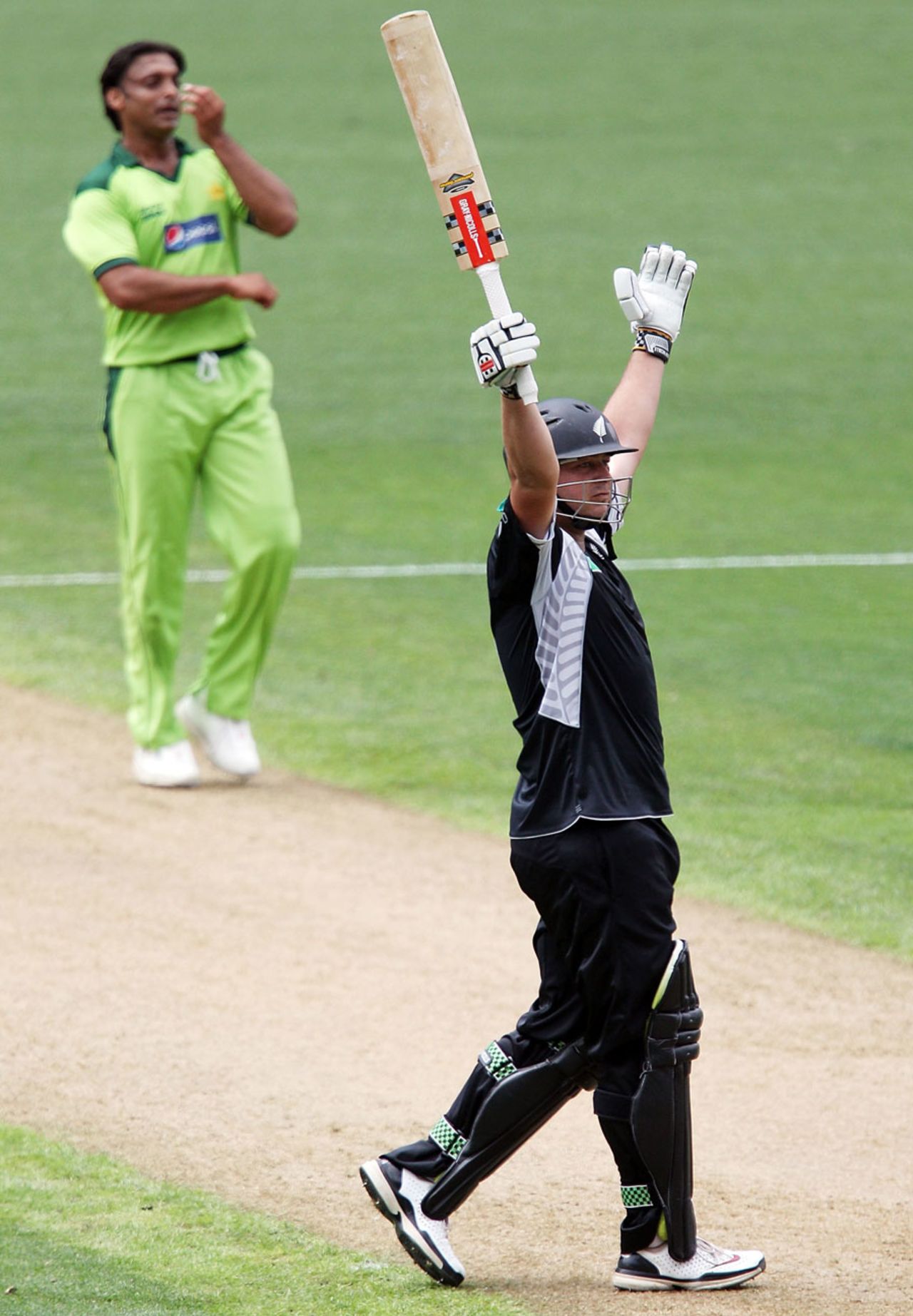 Jesse Ryder is pleased to reach his century, as Shoaib Akhtar watches, New Zealand v Pakistan, 6th ODI, Auckland, February 5, 2011