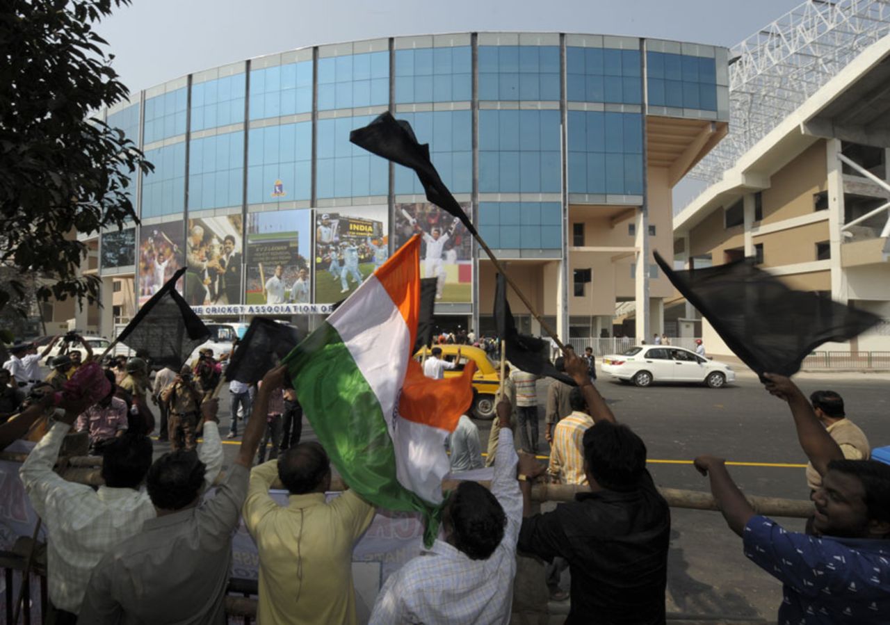 Demonstrators wave black flags outside Eden Gardens in protest of the ICC's decision to strip the ground of a World Cup match, Kolkata, February 7, 2011
