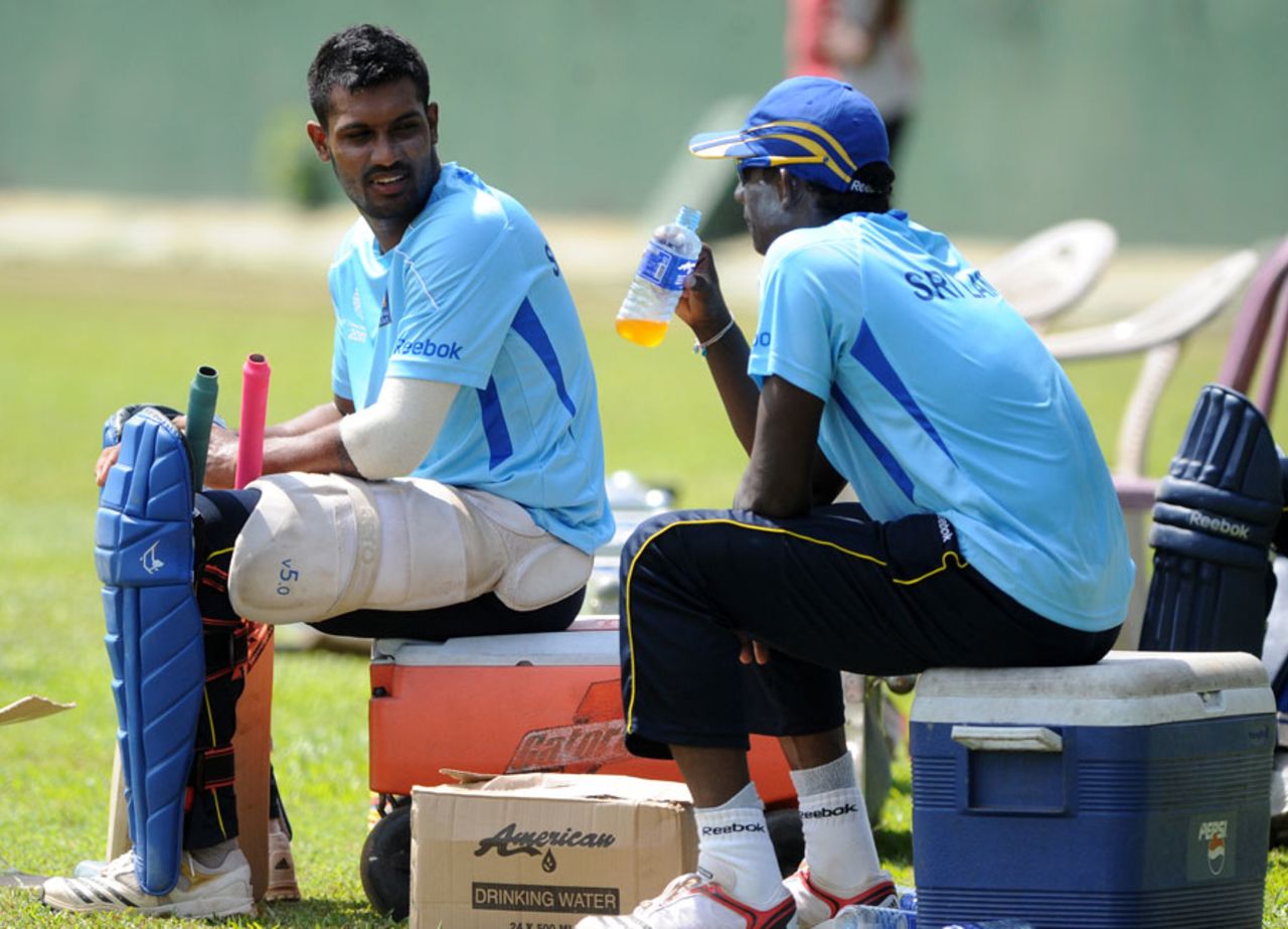 Chamara Kapugedera and Ajantha Mendis take a break during practice at the SSC, Colombo, February 11, 2011