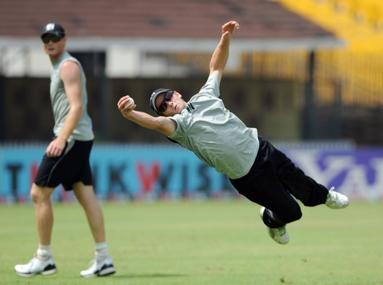 Kane Williamson takes a blinder while training as Martin Guptill looks on, Chennai, February 14, 2011