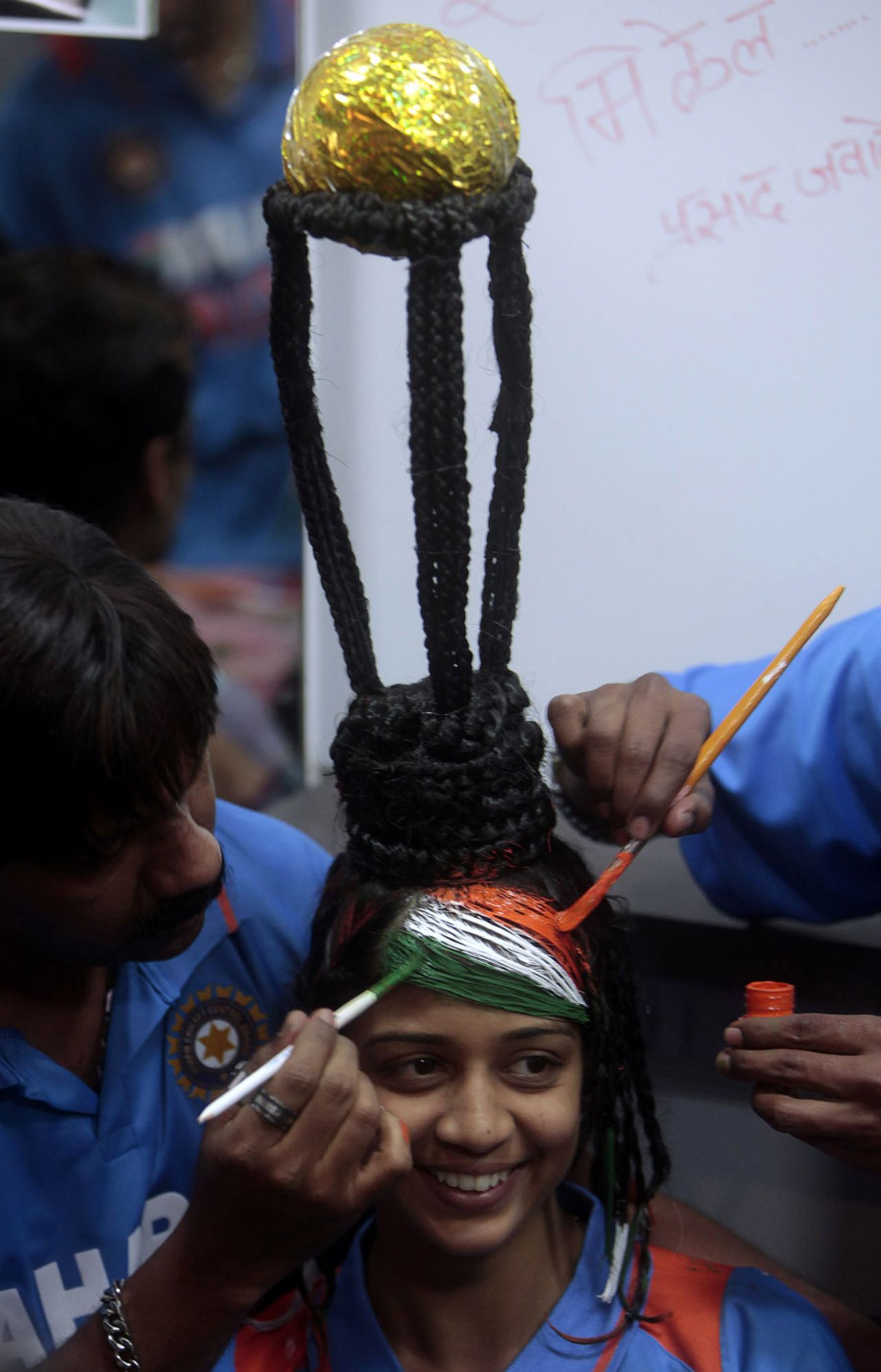 A cricket fan has her hair styled to resemble the World Cup trophy, Mumbai, February 17, 2011