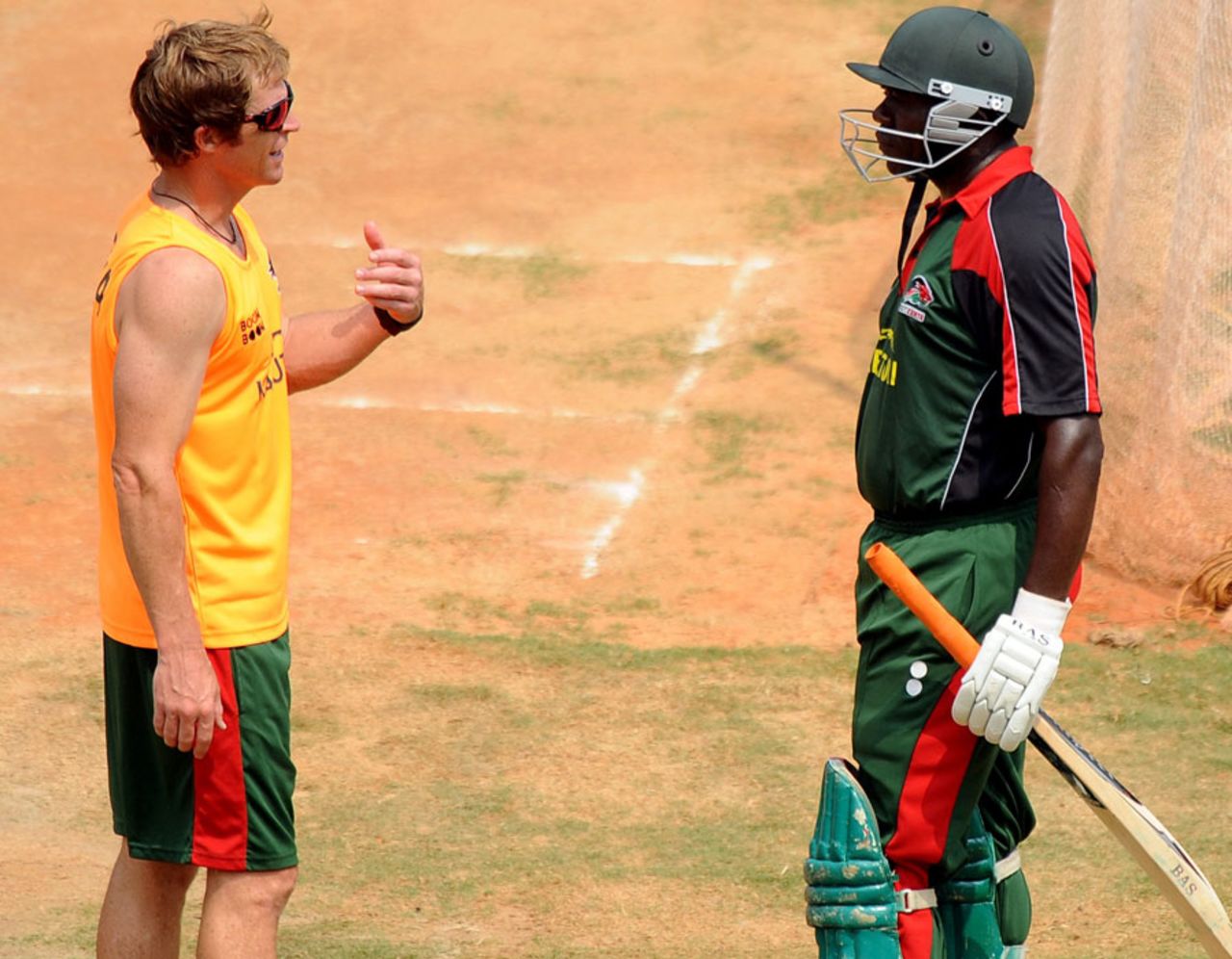 Kenya's specialist consultant Jonty Rhodes discusses a point with Steve Tikolo, Chennai, February 18, 2011