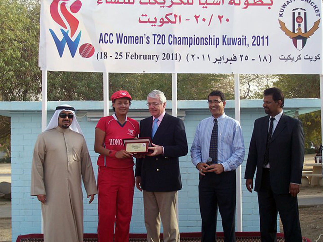 Connie Wong receives her Player of the Match award from former British Prime Minister John Major after Hong Kong beat Nepal in the ACC Women's Twenty20 semi-final played in Kuwait on 24th February 2011