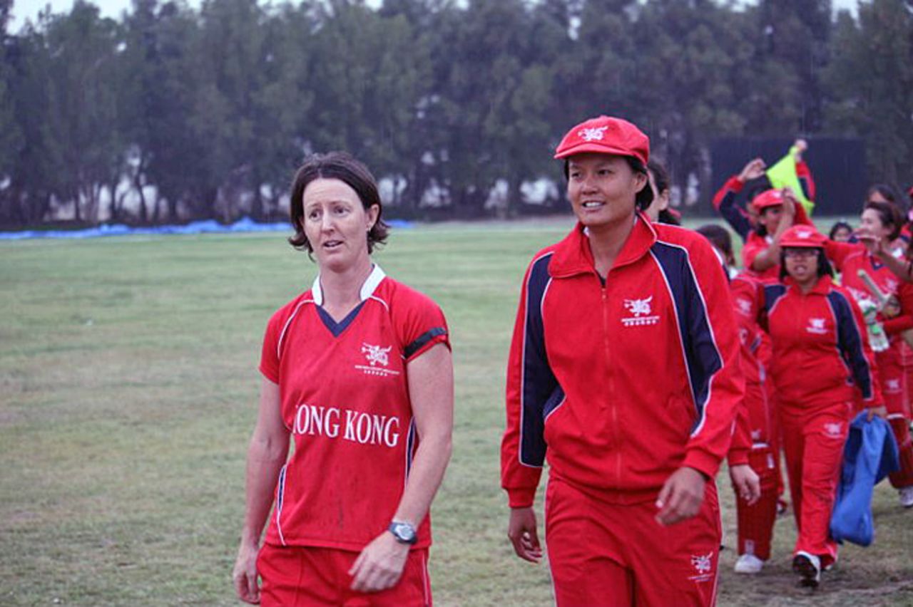 Champions - Neisha Pratt and Connie Wong lead the victorious Hong Kong team off the field after beating China by three wickets in the ACC Women's Twenty20 final in Kuwait on 25th February 2011