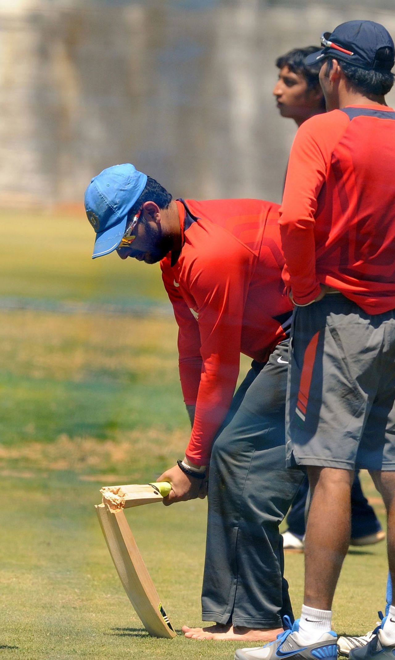 Yuvraj Singh breaks a bat during India's training session, Bangalore, March 3, 2011