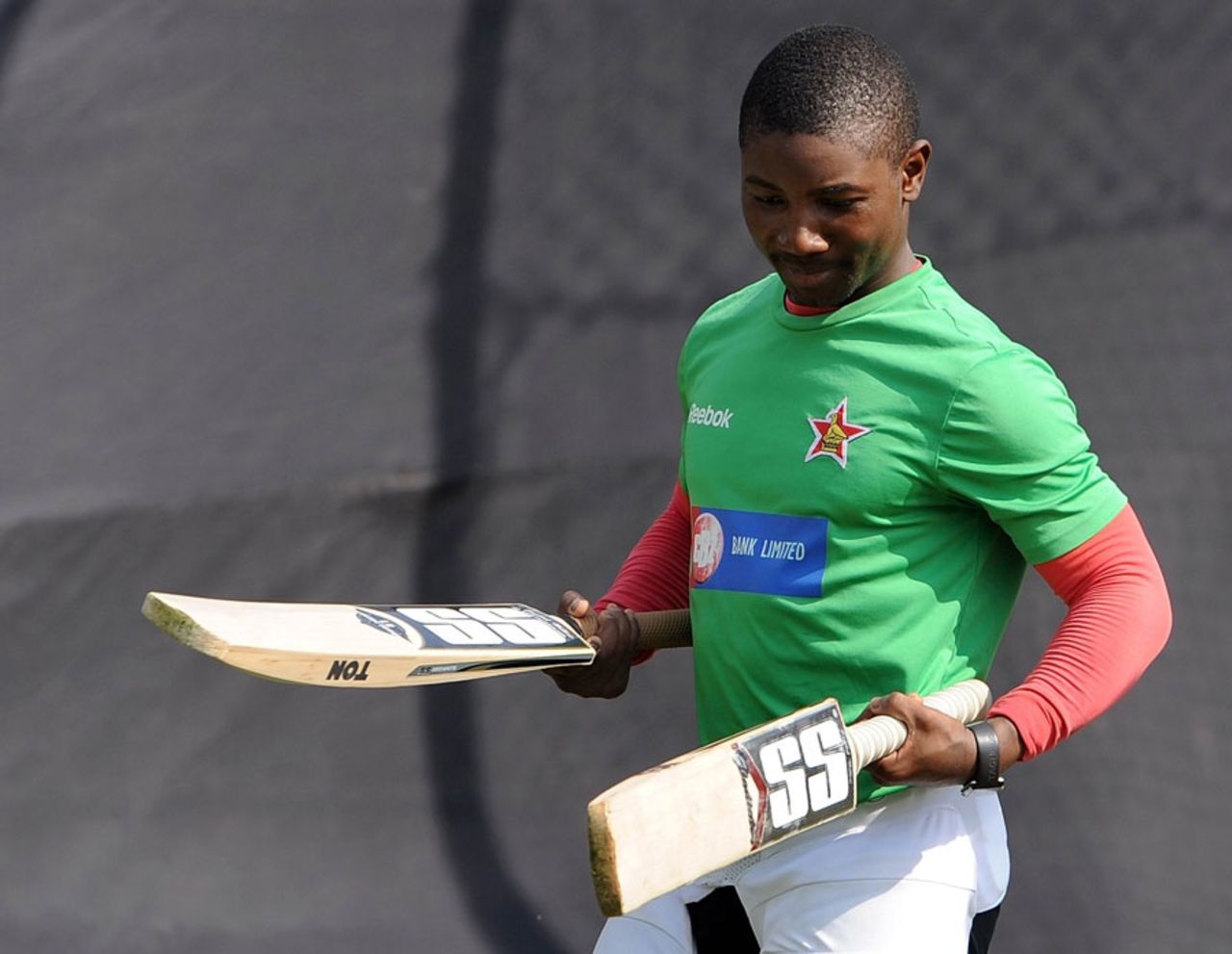 Tatenda Taibu inspects his bats during practice, Ahmedabad, February 3, 2011