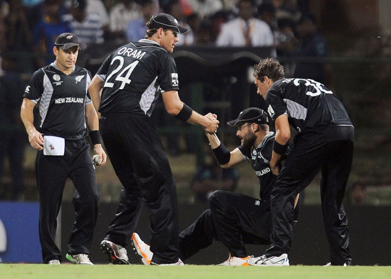Daniel Vettori is helped up by his team-mates after hurting his knee, New Zealand v Pakistan, Group A, World Cup, Pallekele, March 8, 2011
