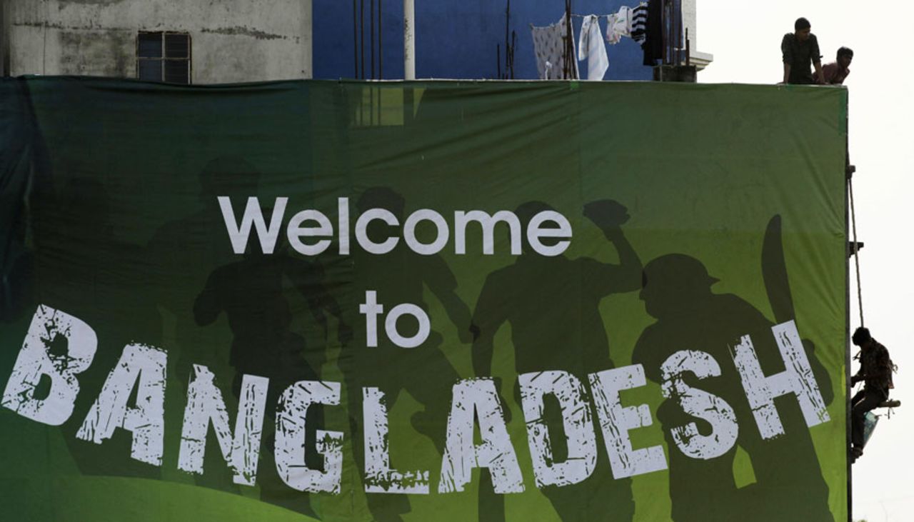 Workers put up a sign opposite the Shere Bangla Stadium, Mirpur, March 18, 2011