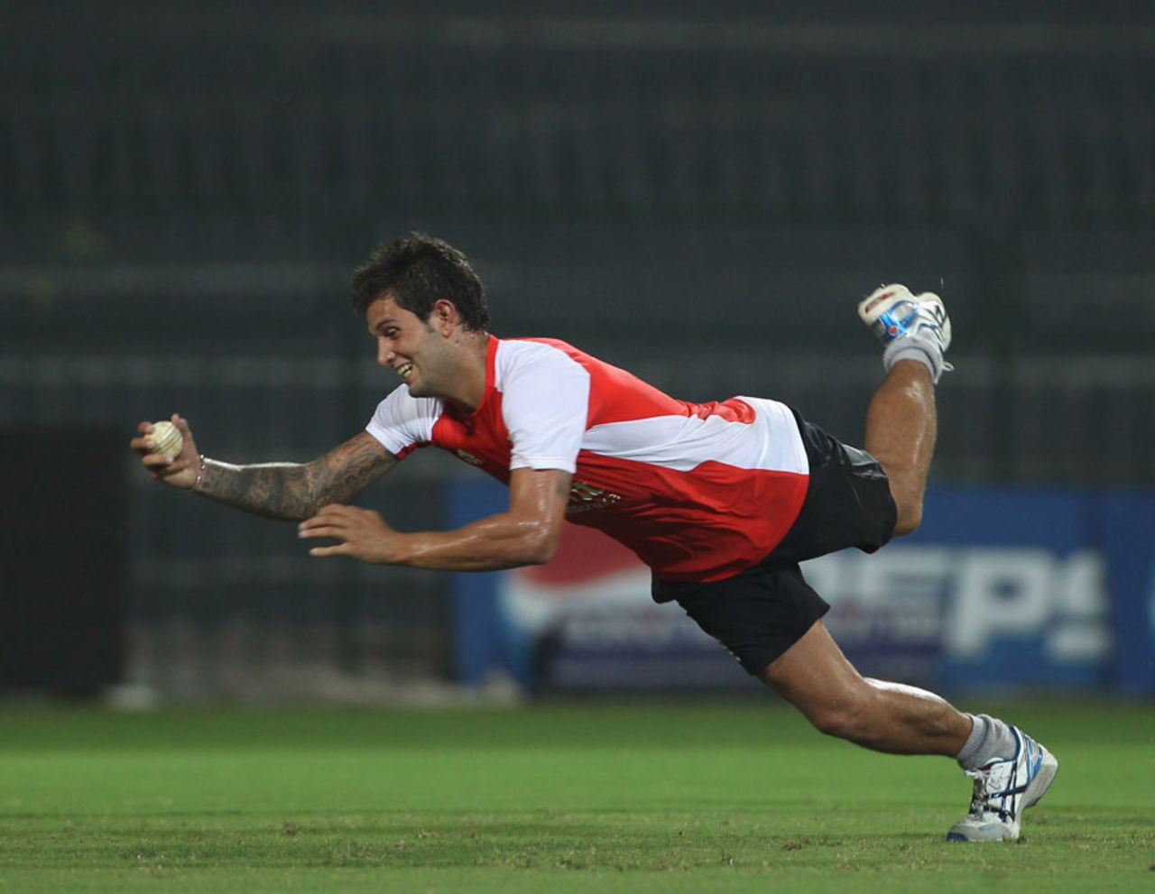 Jade Dernbach, England's replacement for Ajmal Shahzad, launches himself at the ball during fielding practice, Colombo, March 22, 2011