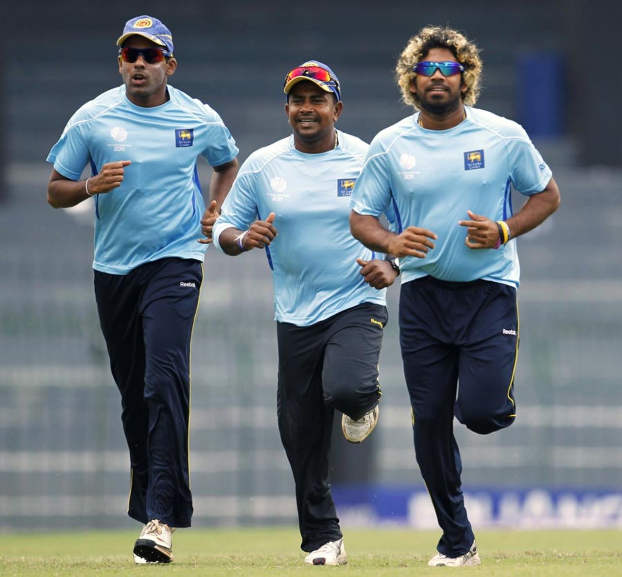 Thilan Samaraweera, Rangana Herath and Lasith Malinga jog during training, World Cup, Colombo, March 23, 2011