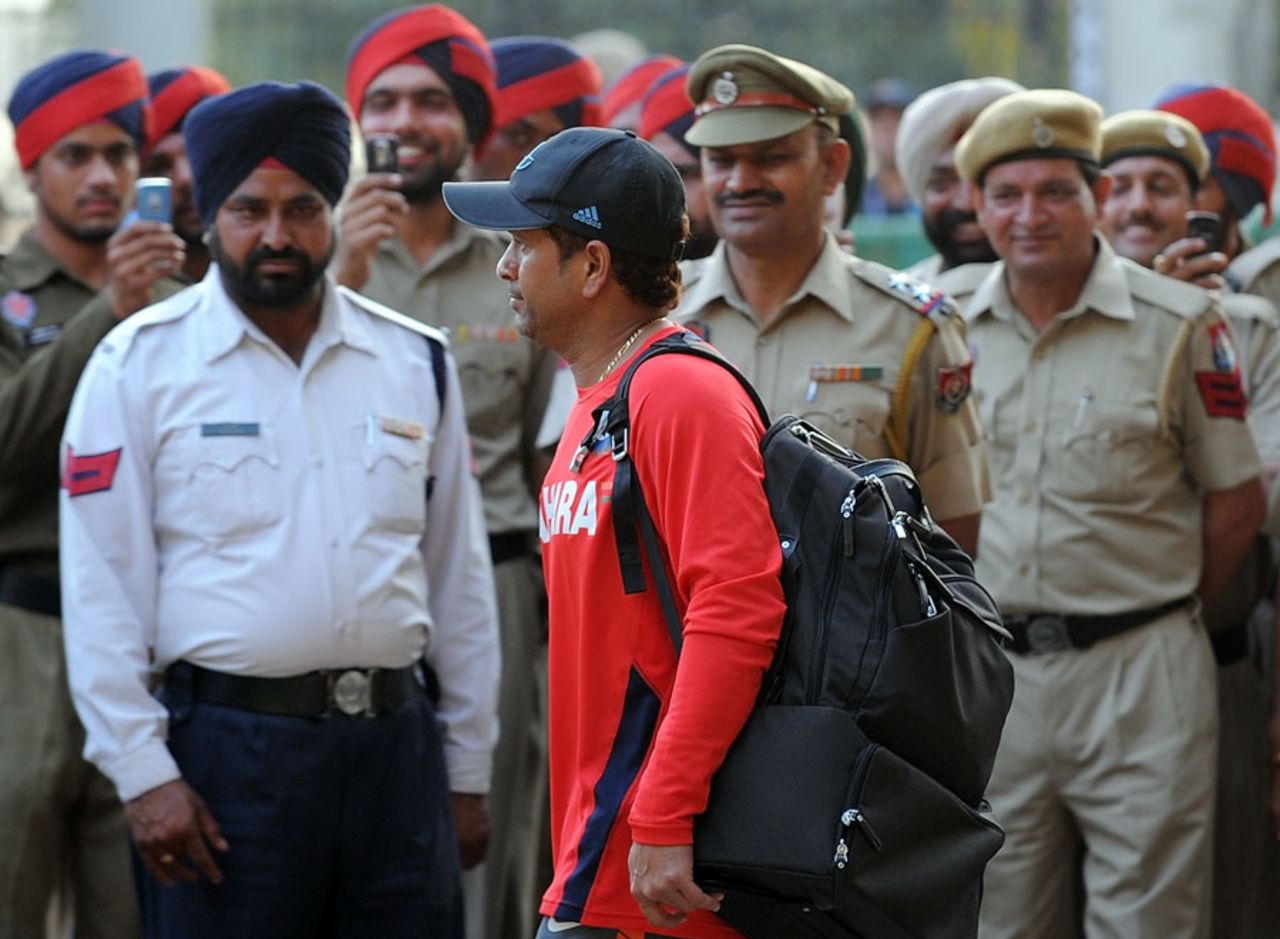 Police officers look on as Sachin Tendulkar leaves the ground, Mohali, March 28, 2011