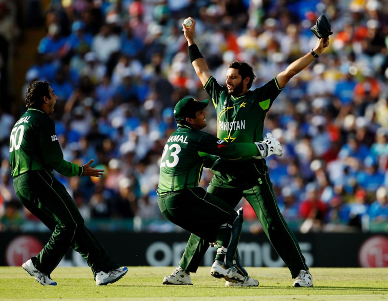 Saeed Ajmal and Kamran Akmal rush to celebrate Sachin Tendulkar's dismissal with Shahid Afridi, World Cup 2011, Mohali, March 30, 2011